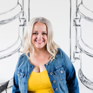 Dawn Taylor, a woman with grey hair and a jean jacket, smiling into the camera