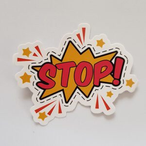 A red and yellow sticker in a comic styling that reads "Stop'